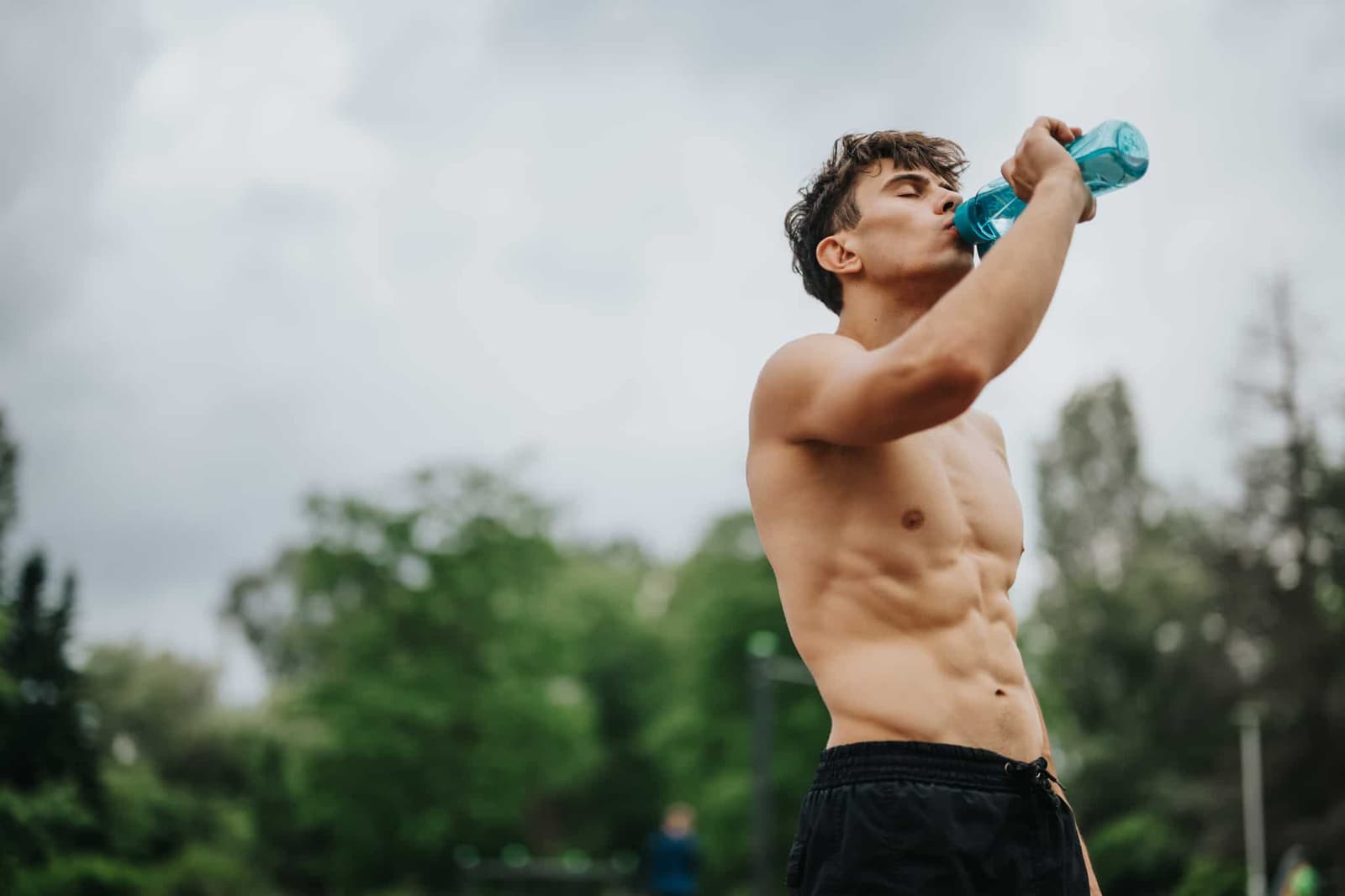 An athlete is drinking water after a workout.
