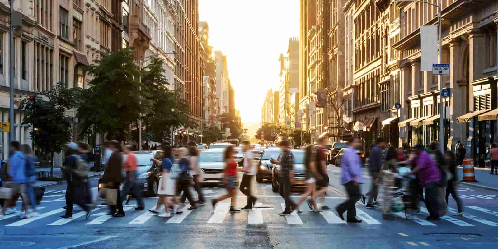 A group of pedestrians is seen walking through a city.
